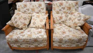 An Ercol ash and woven cane bergere three piece suite, two seater sofa and pair of armchairs,