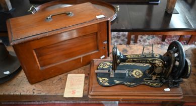 An antique Singer sewing machine with case