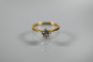 A single stone diamond ring, the brilliant cut diamond in coronet setting with scroll shoulders,