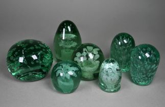 Four Stourbridge green glass 'dumps' with internal floral designs to/w three dumps with bubbles,