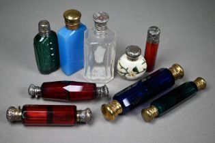 Two Victorian ruby glass double-ended scent bottles with unmarked white metal caps, a blue example