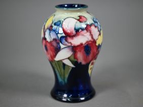 A Walter Moorcroft baluster vase, decorated with irises, 15 cm
