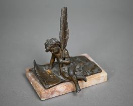 After Ernest Justin Ferrand (1846 - 1932) a bronzed figure, Cupid writing a letter, on marble