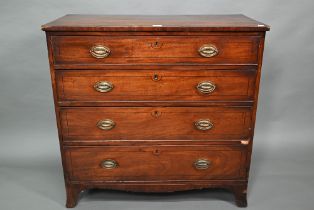 A 19th century mahogany chest of four long graduated drawers, raised on spayed bracket feet, later