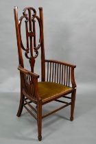 An Arts & Crafts Liberty style carver chair, with shaped back and fabric seat