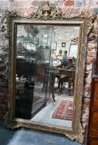 An antique French gilt gesso mirror, surmounted by a garland festooned urn, 155 cm h x 102 cm