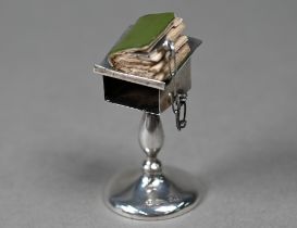 A novelty silver miniature lectern, containing a miniature New Testament (book a/f), Henry