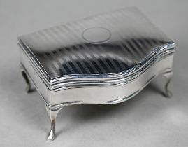 A silver serpentine-front ring box with fitted blue velvet lining, on cabriole supports, Martin,
