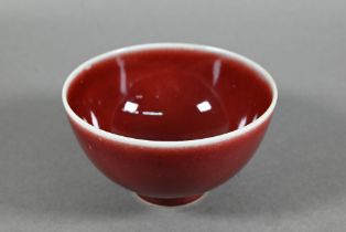 A Chinese Lang Yao/sang-de-boeuf bowl, covered with a rich copper red glaze, contrasting white rim