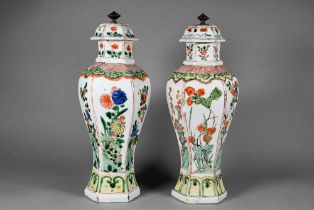 A matched pair of Chinese Kangxi period (1662-1722) wucai decorated vases with covers of octagonal