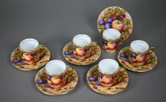 A boxed set of six each Aynsley coffee cans and saucers, printed with fruit (one saucer chipped