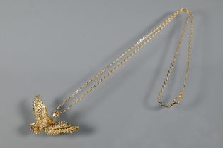 A 9ct yellow gold pendant in the form of an eagle with outstretched wings, on chain stamped 375,