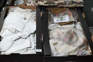 Two boxes of mixed textiles including table linens, two chintz patchwork coverlets, etc