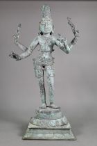 A large Indian bronze figure of the Hindu deity Shiva standing on a stepped lotus base in the