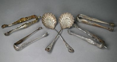 A pair of 19th Century French .800 grade parcel gilt sugar tongs and three other pairs, to/w a