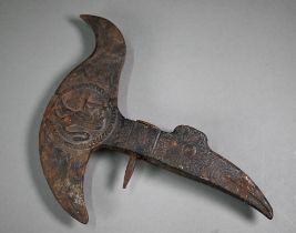 An antique iron ceremonial axe-head, the recurved blade cast with medallion of a mounted soldier,