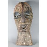 A West African carved wood Songye mask (Kifwebe) Democratic Republic of Congo, with incised linear