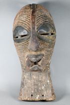 A West African carved wood Songye mask (Kifwebe) Democratic Republic of Congo, with incised linear