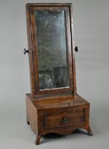 A compact 19th century mahogany toilet mirror, raised on a single bow-fronted drawer base, on