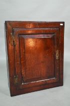 A small 18th century oak wall cabinet, 47 cm x 19 cm x 55 cm h