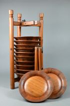 A set of twelve traditional Chinese pine plates stacked in a caddy rack carrier, 20th century, 54 cm