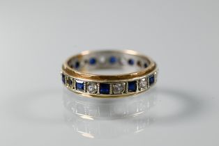 A 9ct yellow and white gold eternity ring set alternate blue sapphires and white stones, size O,