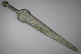 A Bronze Age sword, the tapering fullered blade with midrib, extending from oval shoulder, with