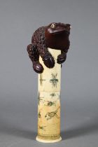 A late 19th century Japanese scroll holder, the cylindrical bone case with tubular insert incised