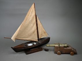 A model sailing dinghy, with card inscribed 'Model of Malay 'Dukone' made by Dick the Malay Pilot,