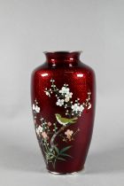 A 20th century Japanese cloisonne vase decorated with a perching song bird amongst cherry blossom in