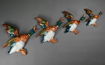 A graduated set of four Beswick flying duck wall ornaments, 26-14 cm