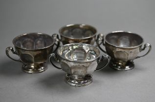 A set of four silver salts with scroll handles and stemmed foot, Sibray, Hall & Co., Sheffield 1919,