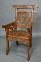 A Japanese Arts & Crafts Liberty armchair, constructed in sections and carved with sunflowers