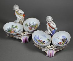 Two 19th century Berlin porcelain double salts, modelled as putti, their baskets painted with