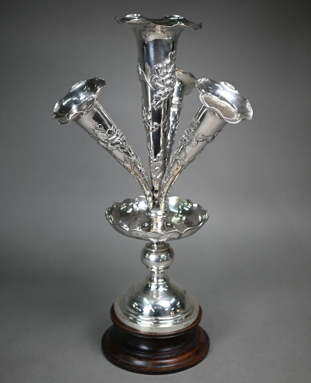 A Chinese .90 grade export silver epergne, the four flutes embossed with birds and flowers, rising