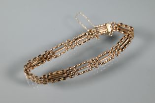 A rose gold gatelink bracelet with concealed clasp and safety chain attached, stamped 15, approx
