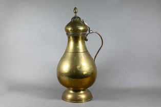 An antique Persian brass water carrier with hinged cover and loop handle, decorative horizontal