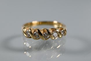 A five-stone diamond ring, the round brilliant cut diamonds in rope-style setting, yellow metal