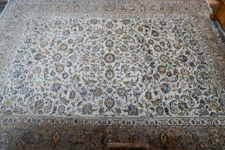 A Central Persian signed Kashan carpet, pale celadon ground with well-executed floral vine design,