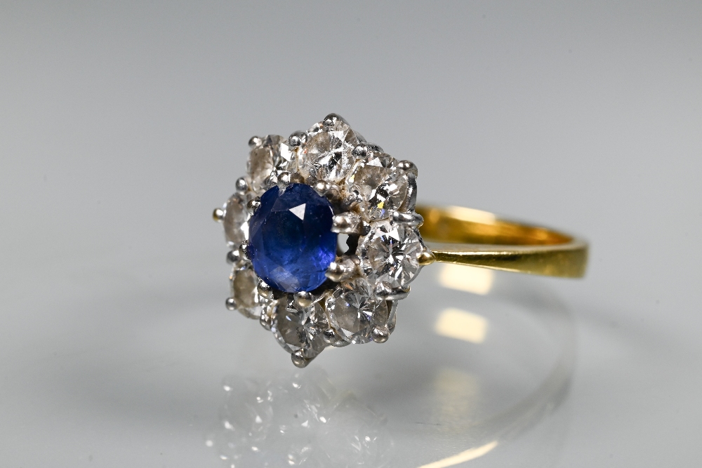 A sapphire and diamond cluster ring, the claw set blue sapphire surrounded by eight brilliant cut - Image 4 of 6