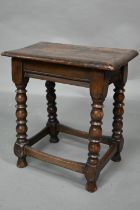 A 17th century style elm seat joint stool, with turned supports, 45 cm x 27 cm x 49 cm h