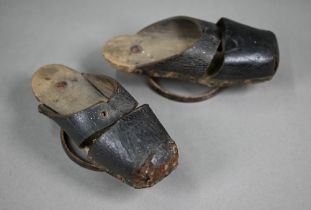 A pair of early 18th century children's leather pattens/overshoes, wooden soles raised by iron