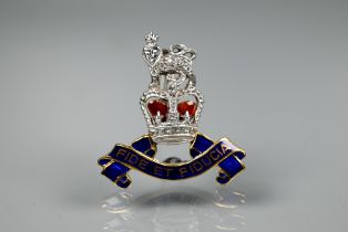 A diamond set 9ct yellow and white gold British Army Pay Corps sweetheart brooch with blue and red