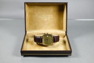 A 14ct gents Longines calendar wristwatch, quartz movement, the case-back with presentation