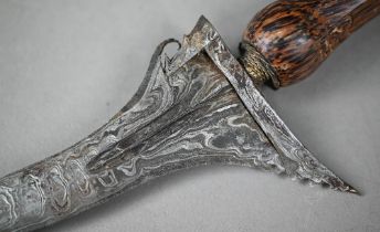 An Indonesian sword Kris with ornate recurved blade, 34 cm, with carved palm-wood grip and scabbard