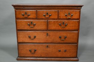 A small 18th century oak chest of three short over two short and two long graduated drawers, with