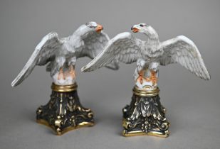 A pair of Continental porcelain spread eagle desk-ornaments, mounted on brass bases, 10.5 cm high