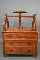 A late 19th century walnut book press chest, the brass bound nautical style adjusting wheel over