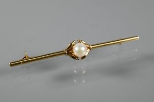 Mikimoto - A yellow metal bar brooch with central pearl, stamped Mikimoto Tokyo KI4, 6.5 cm long,