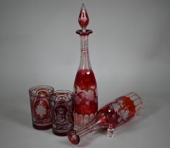 A pair of 19th century German ruby flash glass beakers, cut and etched with armorials, floral sprays